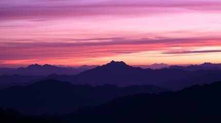 Fototapeta premium Silhouetted mountain ridge beneath purple twilight