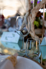 Close-up of a glass on a restaurant table with a softly blurred background. The dreamy bokeh effect...