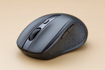 A matte gray computer mouse rests on a tan surface It has a scroll wheel and side buttons