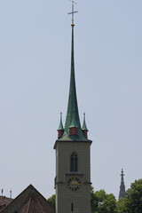Tall church spire against a clear sky, showcasing classic architecture and a serene, timeless presence. Elegant and historically rich.