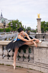 Ballerina stretching at historic bridge in Paris city center