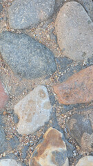 Full frame Nature background of old gray road stone pavement, close up organic black stone texture for wall, abstract photo for interior or exterior design of large cobblestones, abstract backdrop