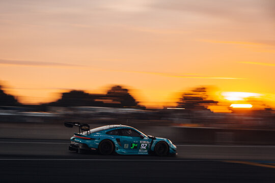 Porsche 911 GT3 RSR go fast at the night track during 24h of Le Mans 