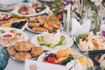 Delicious spread of gourmet dishes showcased at a vibrant garden party in the afternoon sun, inviting friends to indulge in a culinary experience filled with flavors and colors