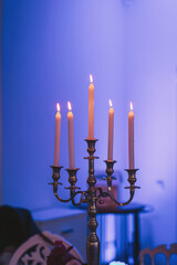 Elegant candlelight illuminates a serene gathering in a softly lit room filled with warm ambiance...