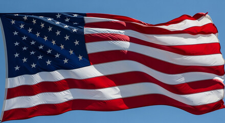 Obraz premium A vibrant American flag unfurling against a clear blue sky, symbolizing patriotism, freedom, and national pride. This iconic United States banner represents democracy and unity, ideal for national