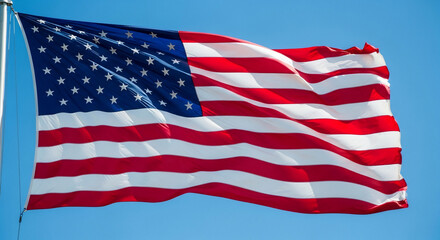 Fototapeta premium The vibrant American flag proudly waves against a clear blue sky, symbolizing patriotism, freedom, and national pride. Perfect for historical, political, or celebratory themes and national holidays