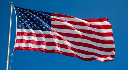 Obraz premium The vibrant American flag proudly waves against a clear blue sky on a bright sunny day, symbolizing freedom, patriotism, and national pride. Ideal for Fourth of July, Veterans Day, election