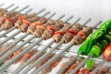Raw kebab skewers ready for grilling.