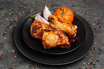 juicy golden grilled barbecue meat with spices on dark background