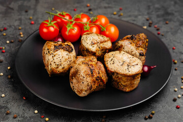 juicy golden grilled barbecue meat with spices on dark background