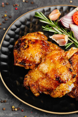 juicy golden grilled barbecue meat with spices on dark background