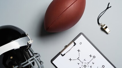 Top-down flat lay of football gear and small U.S. flag on white background. Clean, modern studio setup, no people, balanced composition