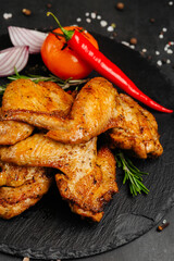 juicy golden grilled barbecue meat with spices on dark background