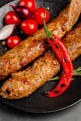 juicy golden grilled barbecue meat with spices on dark background
