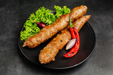 juicy golden grilled barbecue meat with spices on dark background