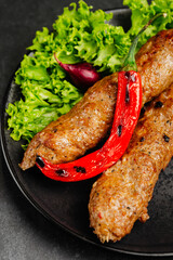 juicy golden grilled barbecue meat with spices on dark background