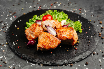 juicy golden grilled barbecue meat with spices on dark background