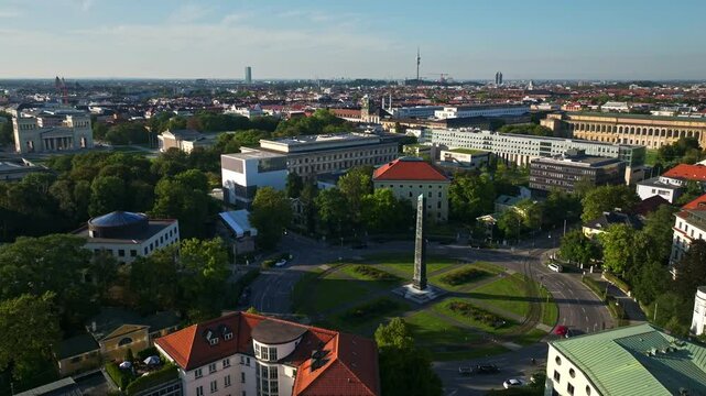 Aerial drone view of the Obelisk of King Ludwig I on Karolinenplatz in Munich, Germany, a historic war memorial surrounded by a circular plaza and neoclassical architecture.. 30 September 2024.
