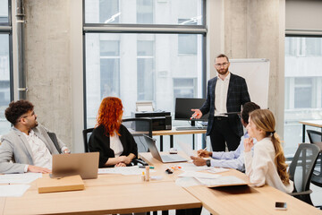 Business team meeting: manager leading a presentation in the office