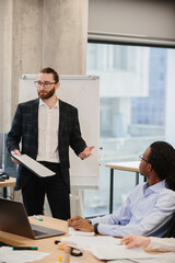 Businessman leading a presentation in a modern office meeting room