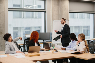 Businessman leading presentation during office meeting