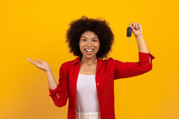 New Vehicle. Excited Young Black Woman Holding Car Key In Her Hand, Overjoyed African American...