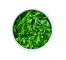 Chopped parsley in a ceramic bowl isolated on white background. Top view.