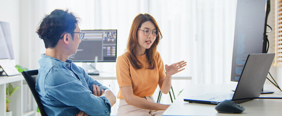 Asian male, female programming developer work together at home office, brainstorm discussion. Information technology, software engineer programmer coding job, man woman coworker teamwork. Copy space