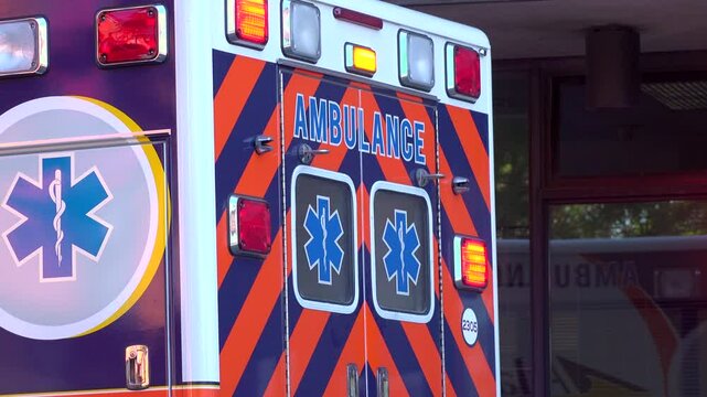Emergency vehicle ambulance sitting in front of building 4k

