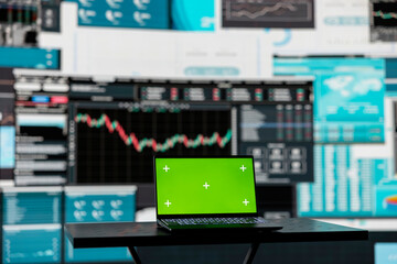 In a business related space, laptop display shows green screen to help with strategy planning with financial data. Representing modern artificial intelligence and productivity for growth.