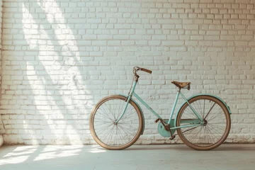 Fototapete Rund Vintage turquoise bicycle resting against a white brick wall bathed in soft, diffused natural light. © nikini