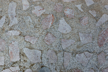 Natural texture of old concrete wall with stone inclusions