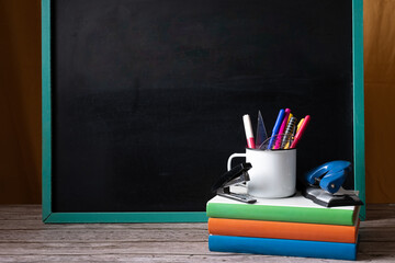 Back to school. School supplies, blackboard, colorful books.