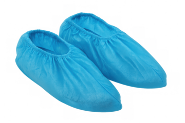 Blue disposable shoe covers protecting medical staff, preventing contamination in sterile environments, positioned against transparent backdrop