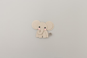Cute paper elephant with soft features on neutral background, ideal for baby products, nursery decor, children book illustration, craft templates, early learning brands,