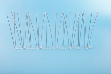 bird spikes with upward and outward angled rods on clear plastic bases. Ideal for property managers, bird control consultants, and building protection suppliers.