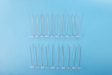 Angled metal bird deterrent spikes mounted in two rows with plastic bases. Perfect for DIY homeowners, pest control retailers, and commercial property service providers