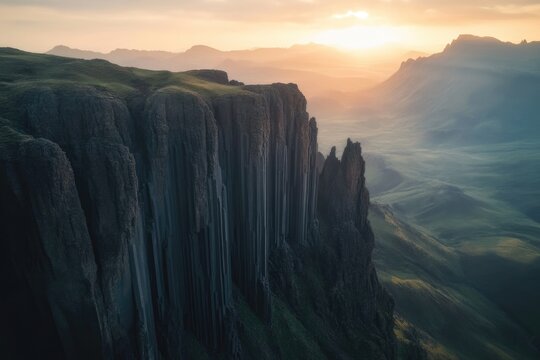 Dramatic basalt cliffs meet a hazy valley, illuminated by a setting sun in a breathtaking landscape. - Powered by Adobe