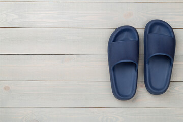 Blue sandals on wooden background,top view