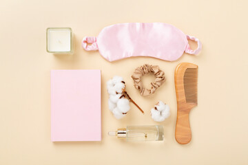 Sleeping mask with accessories on color background, top view. Sleeping routine concept