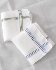 Classic men’s handkerchiefs with striped pattern on light background.