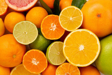 Different citrus fruits on wooden background, top view