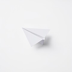 Fototapeta premium A simple white paper airplane on a white background. The image evokes feelings of childhood, dreams and travel.