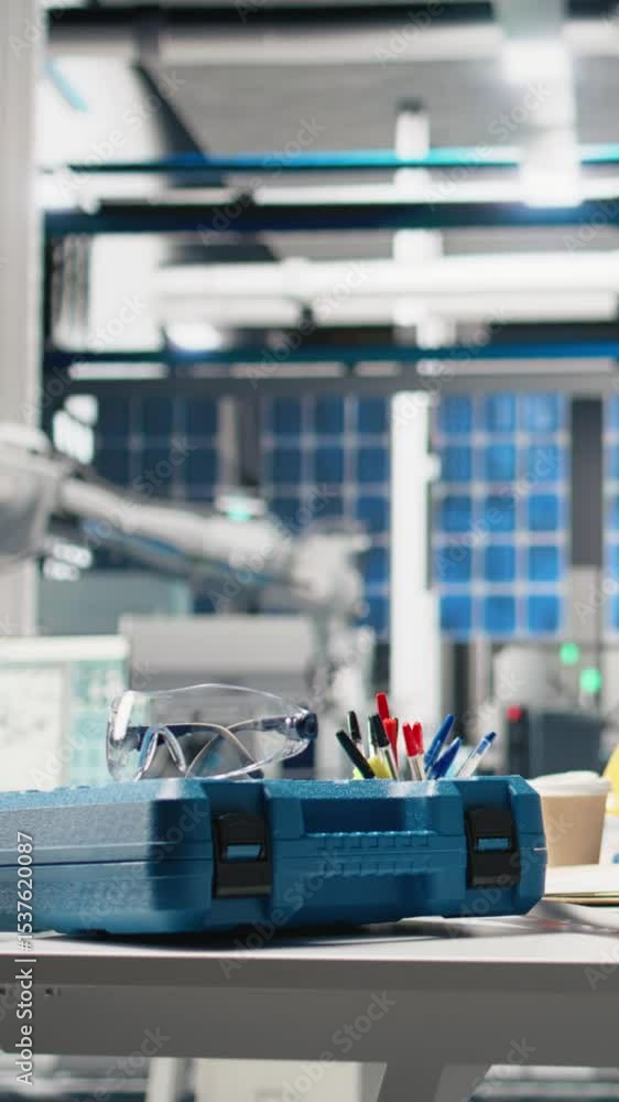 Poster vertical video empty engineering workspace in a high tech solar panels factory, featuring robotic ar