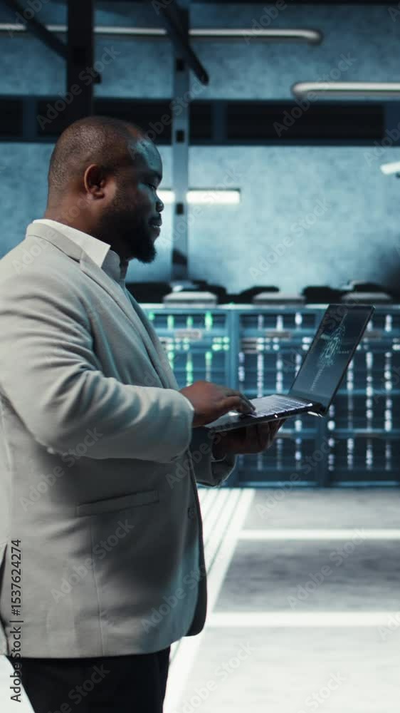 Poster vertical video server room system administrator using laptop to do infrastructure ai machine learnin
