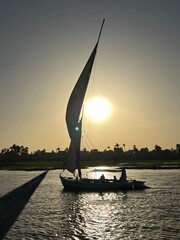 Felucca sailboat at sunset over the Nile in Egypt