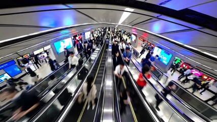 Crowd of passengers moving on escalators in hong kong subway