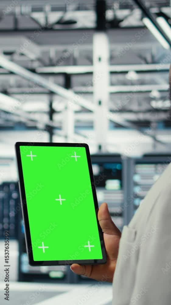Poster vertical video admin working in server farm using isolated screen tablet to analyze data. it expert 