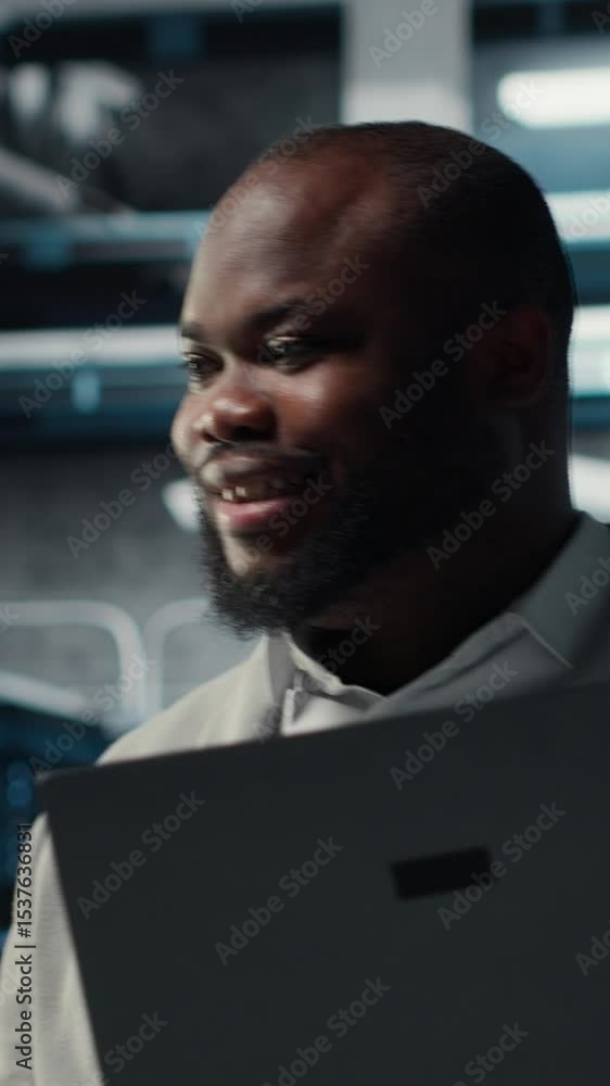 Poster vertical video happy engineer walking in data center, configuring storage devices for minimal latenc